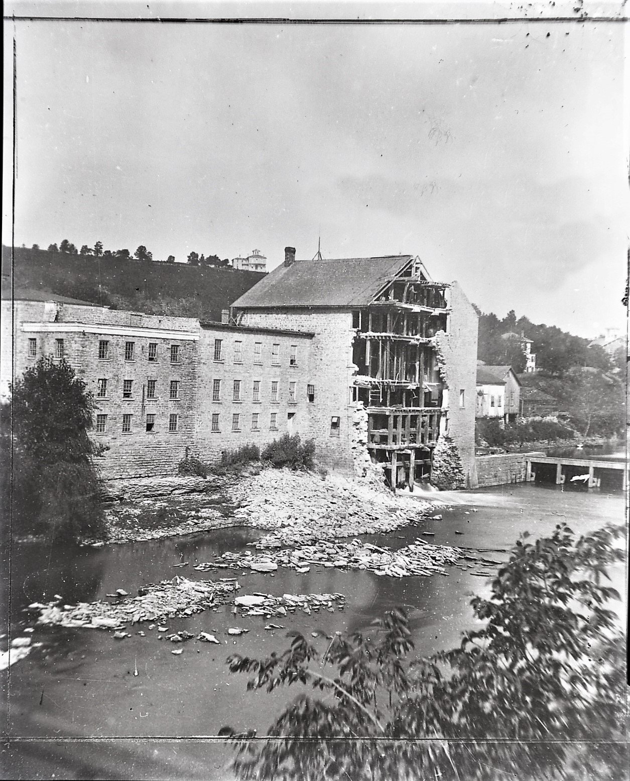 The mill with its river wall torn open after the flood of June 1880